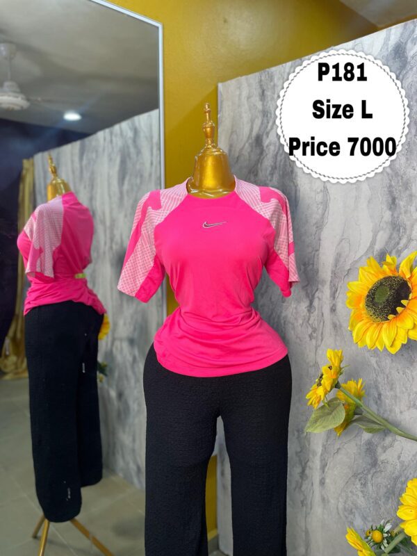P181 - Pink Nike polo (L)